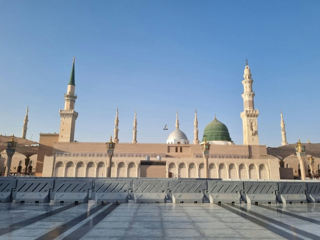 Stunning view of Al-Masjid an-Nabawi's architecture under a clear blue sky.