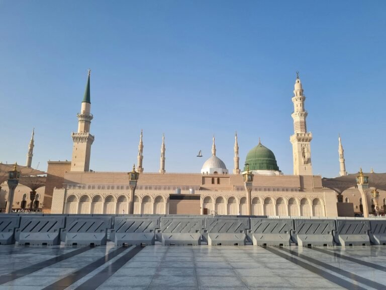 Stunning view of Al-Masjid an-Nabawi's architecture under a clear blue sky.