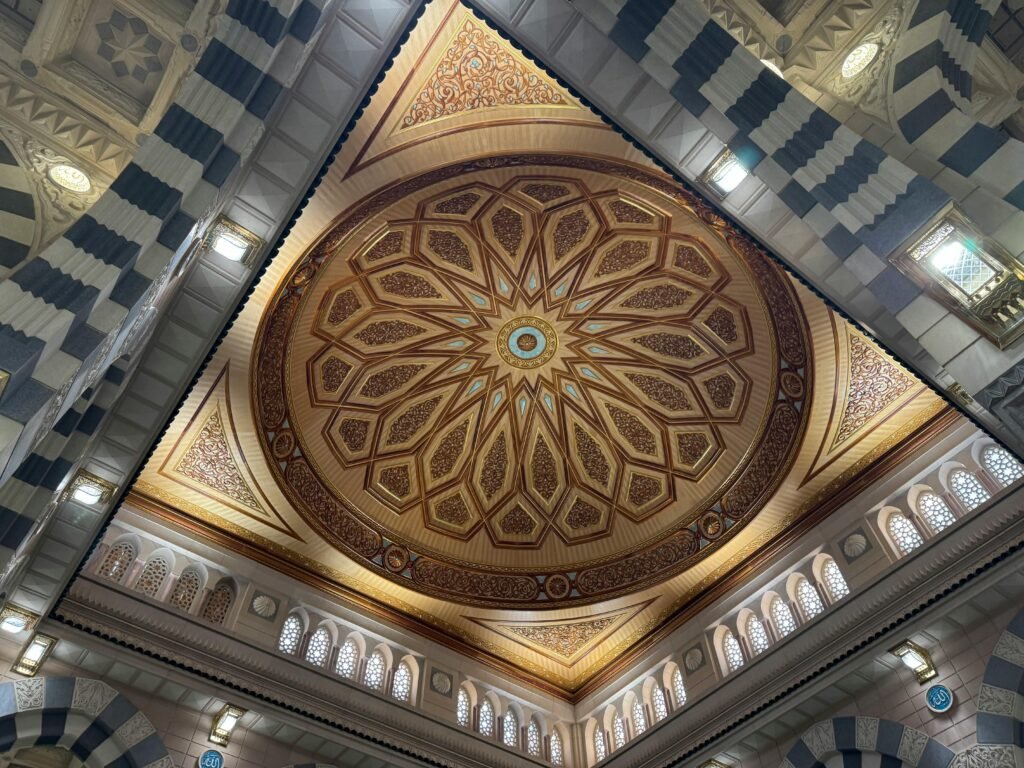 Detailed view of the ornate ceiling dome in a Medina mosque showcasing Islamic architecture.